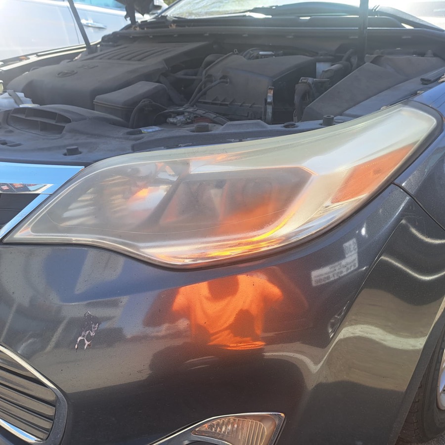 SUV headlight before restoration, hazy and oxidized